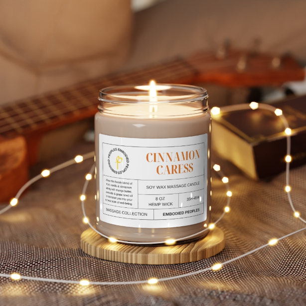 8 oz soy wax massage candle lit. Cinnamon Caress: Allow this heady blend of fruit, vanilla & cinnamon along with mango butter, avocado & grape seed oil to transport you into your richest state of well-being. 